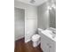 Bright bathroom with new toilet, laminate flooring, and shelving at 12549 Chenwood Ave, Hudson, FL 34669