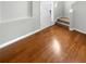 Bright entryway featuring hardwood floors, stairs, and a white front door at 12549 Chenwood Ave, Hudson, FL 34669