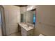 Bathroom with a spacious vanity area, sink, and a large mirror, complemented by decorative wallpaper at 17952 Villa Creek Dr # 17952, Tampa, FL 33647