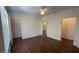 Spacious bedroom with wood floors, ceiling fan, and multiple doors to closets and other rooms at 17952 Villa Creek Dr # 17952, Tampa, FL 33647