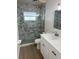 Contemporary bathroom featuring a glass-enclosed shower, neutral tile and an updated vanity at 6050 Coral Way # 4, Bradenton, FL 34207