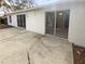 Exterior view of the home's backyard and patio area with white exterior at 8103 Rhanbuoy Rd, Spring Hill, FL 34606