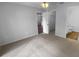 Neutral-colored bedroom featuring neutral carpet, closet and bathroom entryways, with light gray paint at 8103 Rhanbuoy Rd, Spring Hill, FL 34606