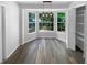 Bright dining area with large bay window and wood floors is the perfect place to enjoy meals at 8103 Rhanbuoy Rd, Spring Hill, FL 34606