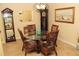 Charming dining room with round table, wicker chairs, and grandfather clock at 20590 Granlago Dr, Venice, FL 34293