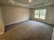 Spacious bedroom with neutral carpeting and large windows for natural light at 13009 Parade Ave, Weeki Wachee, FL 34614