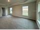 Spacious bedroom with neutral carpeting and multiple windows at 6101 Roble Ave, Spring Hill, FL 34608