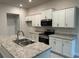 Modern kitchen with white cabinets, granite countertops, and stainless steel appliances at 6101 Roble Ave, Spring Hill, FL 34608