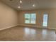 Bright and spacious living room with tile floors and access to backyard at 13106 Nusser Ave, Weeki Wachee, FL 34614