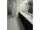 Main bathroom with double vanity, granite countertop, and large walk-in shower at 13106 Nusser Ave, Weeki Wachee, FL 34614