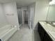 Main bathroom with double vanity, soaking tub, and walk-in shower at 13106 Nusser Ave, Weeki Wachee, FL 34614