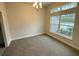 Bright dining room with large window and neutral carpeting at 5356 Frost Rd, Spring Hill, FL 34606