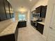 Modern kitchen with dark wood cabinets and granite counters at 5356 Frost Rd, Spring Hill, FL 34606