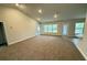 Spacious living area with neutral carpet and large windows at 5356 Frost Rd, Spring Hill, FL 34606