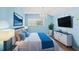 Relaxing bedroom with light blue walls, comfortable bed, and large TV at 19617 Sunset Bay Dr, Land O Lakes, FL 34638