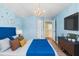 Cozy bedroom with a full bed, blue accents, and a large TV at 19617 Sunset Bay Dr, Land O Lakes, FL 34638