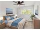 Bright bedroom with a large bed, ceiling fan, and wood-like floors at 19617 Sunset Bay Dr, Land O Lakes, FL 34638