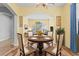 Bright dining room with round table and four chairs, offering a view to the backyard at 19617 Sunset Bay Dr, Land O Lakes, FL 34638