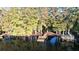 Aerial view showcasing waterfront property with multiple docks at 8531 Bass Lake Dr, New Port Richey, FL 34654