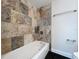 Clean bathroom with a bathtub and updated tile shower surround at 8531 Bass Lake Dr, New Port Richey, FL 34654