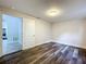 Bright bedroom with wood-look flooring and access to hallway at 8531 Bass Lake Dr, New Port Richey, FL 34654