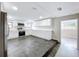 Bright kitchen with white cabinets, stainless steel appliances, and dark tile floors at 8531 Bass Lake Dr, New Port Richey, FL 34654