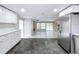 Open concept kitchen with stainless steel appliances and views to the living room at 8531 Bass Lake Dr, New Port Richey, FL 34654