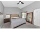 Primary bedroom with king bed, dresser and patio door access at 1228 Cord Grass Ct, Wesley Chapel, FL 33543