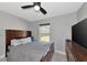 Bedroom with large TV, double bed and dresser at 1228 Cord Grass Ct, Wesley Chapel, FL 33543