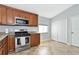 Kitchen with stainless steel appliances and wood cabinets at 1228 Cord Grass Ct, Wesley Chapel, FL 33543