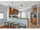 Kitchen island with seating for four and granite countertop at 1228 Cord Grass Ct, Wesley Chapel, FL 33543