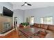 Living room featuring a fireplace and sliding glass doors at 1228 Cord Grass Ct, Wesley Chapel, FL 33543