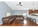 Spacious living room with a leather sectional sofa and hardwood floors at 1228 Cord Grass Ct, Wesley Chapel, FL 33543