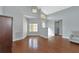 Living room with hardwood floors, high ceilings and view to entryway at 1228 Cord Grass Ct, Wesley Chapel, FL 33543