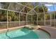 Inviting screened pool and spa at 1228 Cord Grass Ct, Wesley Chapel, FL 33543