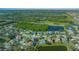 Aerial view of house and neighborhood with pond and golf course in the background at 221 111 E St, Bradenton, FL 34212