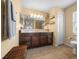 Bathroom with dark brown vanity,tiled floors and a large mirror at 221 111 E St, Bradenton, FL 34212