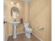 Small half bathroom with pedestal sink and toilet at 221 111 E St, Bradenton, FL 34212