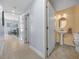 Powder room with pedestal sink, toilet and decorative mirror at 221 111 E St, Bradenton, FL 34212