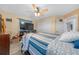 Bedroom with a large TV and striped bedding at 221 111 E St, Bradenton, FL 34212