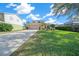 Two-story house with tan garage door and nicely landscaped yard at 221 111 E St, Bradenton, FL 34212