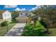 Two-story house with tan garage door, landscaping, and driveway at 221 111 E St, Bradenton, FL 34212