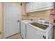 Laundry room with washer, dryer and overhead cabinets at 221 111 E St, Bradenton, FL 34212