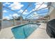 Screened-in pool with patio furniture and lake view at 221 111 E St, Bradenton, FL 34212