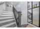 Modern staircase with gray wood and wrought iron railing at 221 111 E St, Bradenton, FL 34212