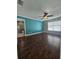 Main bedroom with teal accent wall and hardwood floors at 4152 Banbury Cir, Parrish, FL 34219