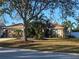 One-story house with a two-car garage, mature landscaping, and a large tree in the front yard at 4152 Banbury Cir, Parrish, FL 34219