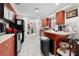 View of the kitchen with wood cabinets, appliances, and a breakfast bar at 5111 Smith Ryals Rd, Plant City, FL 33567