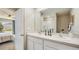 Double vanity bathroom with white cabinets and large mirror at 30916 Wild Juniper Ct, Brooksville, FL 34602