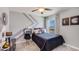 bedroom with gray and white decor, a full-size bed, and a desk at 30916 Wild Juniper Ct, Brooksville, FL 34602